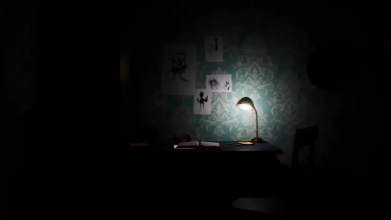 A wooden desk illuminated by a lamp with children's drawings on the turquoise wall - UNANSWERED